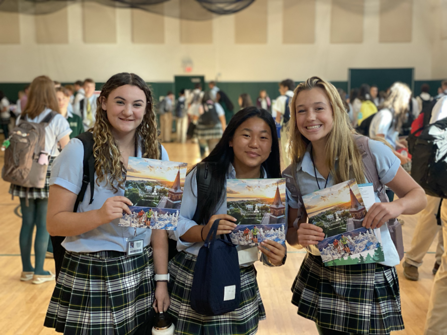 Juniors Ally Styles, Sam Blette and Grace Nelson show off their University of Vermont brochures that they received from a school rep at the college fair. 
