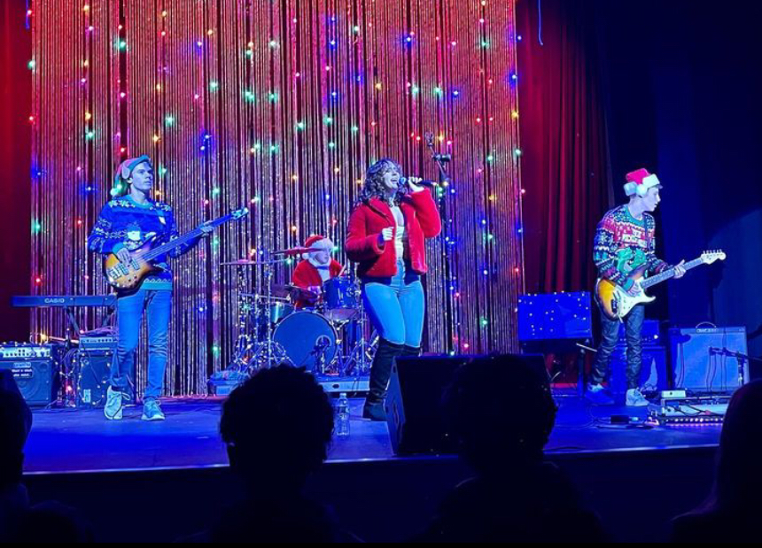 Pictured: (from left to right) Playing guitar is JD Mello, on the drums wearing a rocking Santa costume is Quentin Khan, singing is Bea De Trolio, and also playing guitar is Nick Calamar. 
