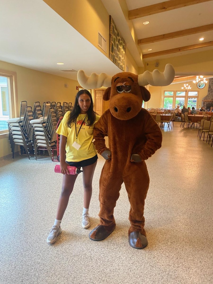 Deepthi Adhavan ‘24 and Oceana Duffy ‘24 (in the moose costume) getting ready to welcome campers to Camp Sunshine.