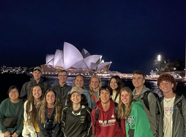 Pictured (left to right; front row) Grace Muliero (‘24), Lilyana Crifo (‘24), Elizabeth Deckett (‘25), Annalise Karamas (‘24), Joey Ahmed (‘24), Emily Roman (‘23) and (left to right; top row) Chris Deckett (‘25), Owen Kobbs (‘25), Bridget Sutula (‘23), Kalmia Cryan (‘23), Maddie Brennan (‘24), Dan Conroy (‘23) and Danny Coady (‘24) in front of the Sydney Opera House’s beautiful night lights. 