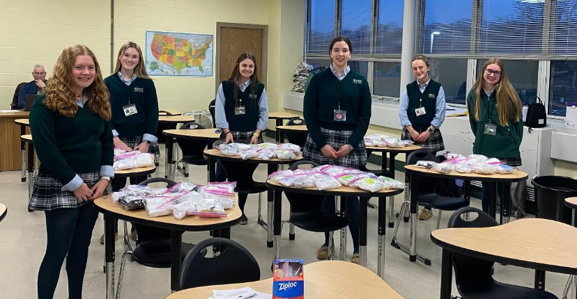 (Pictured left to right) Maddie Kelly  ‘24, Maddie Kent ‘24, Sarah Dupre ‘24, Fiona Soliday ‘24, Elena Flood ‘24, and Kayla Powers ‘24 this past year packaging donated socks into individual bags before they are sent off to local homeless shelters. 