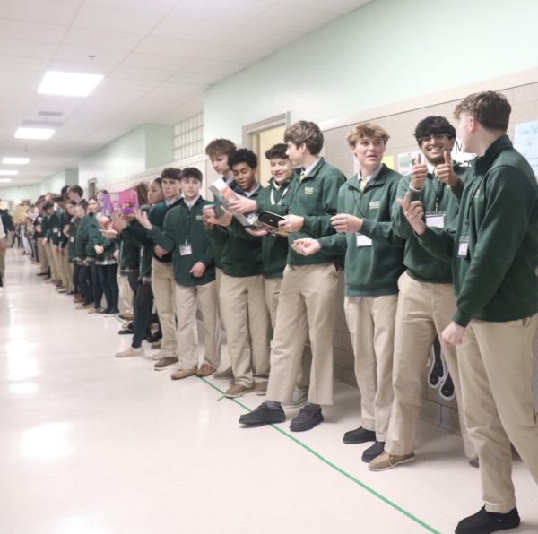 Students line the halls as part of the "toy chain" at Santa Shop every year.