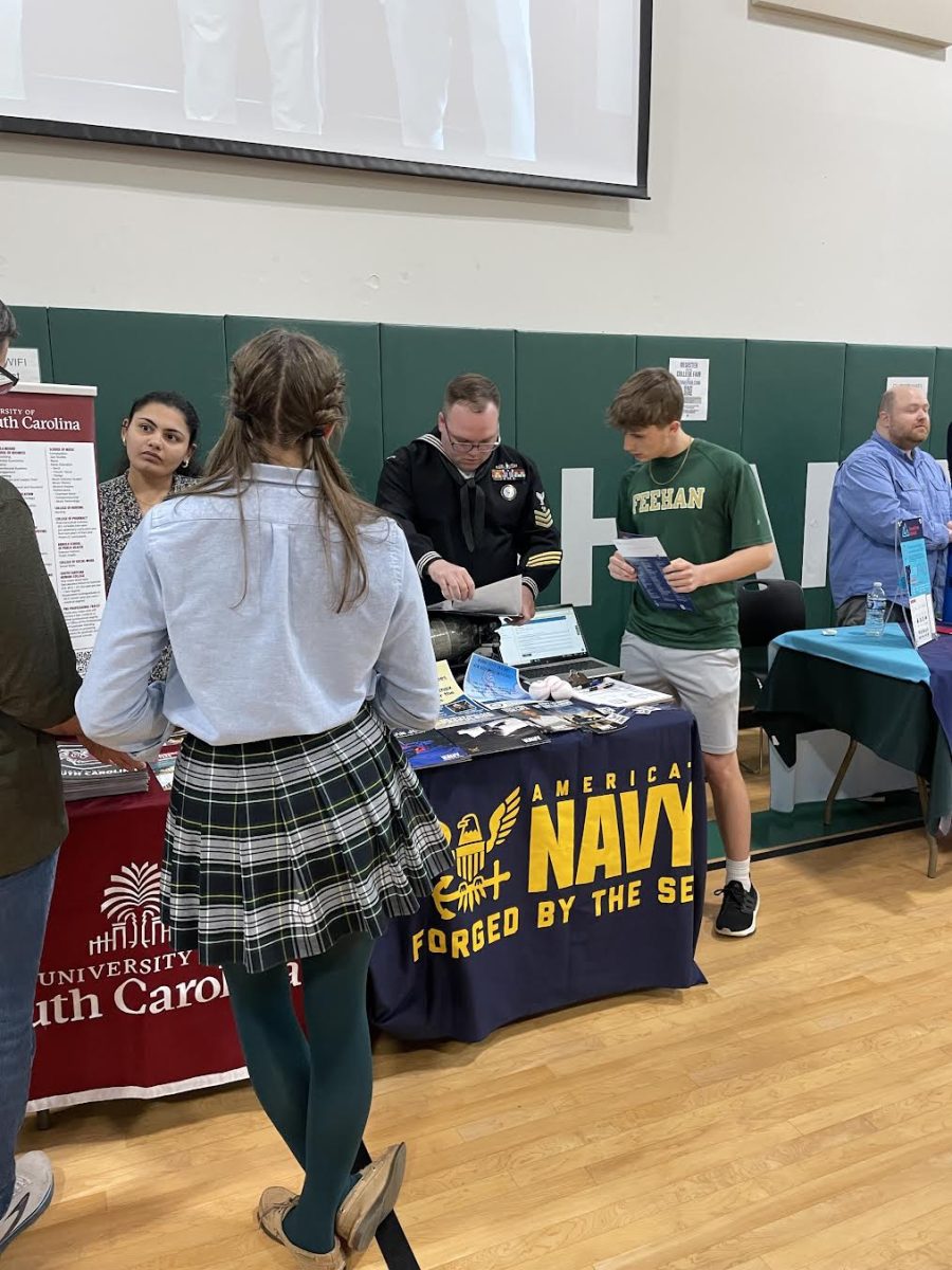 Parents and students speak with admissions representatives at the College Fair