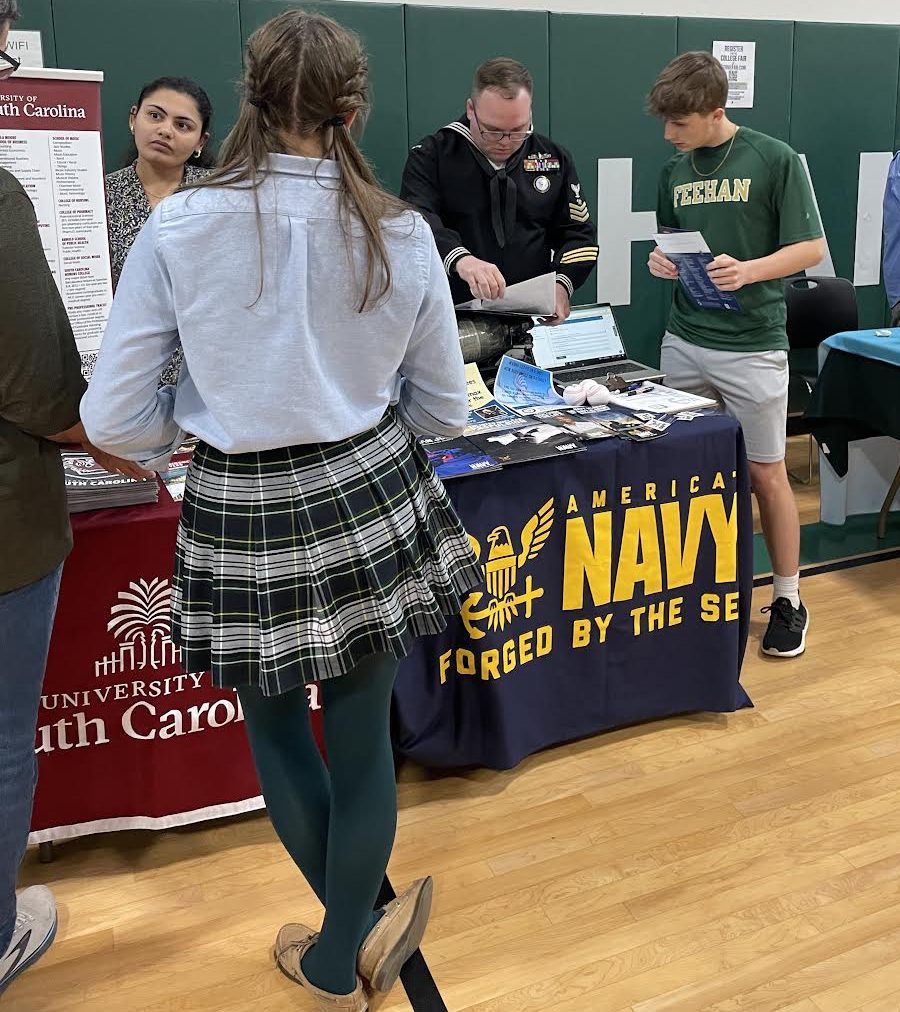 Parents and students speak with admissions representatives at the College Fair