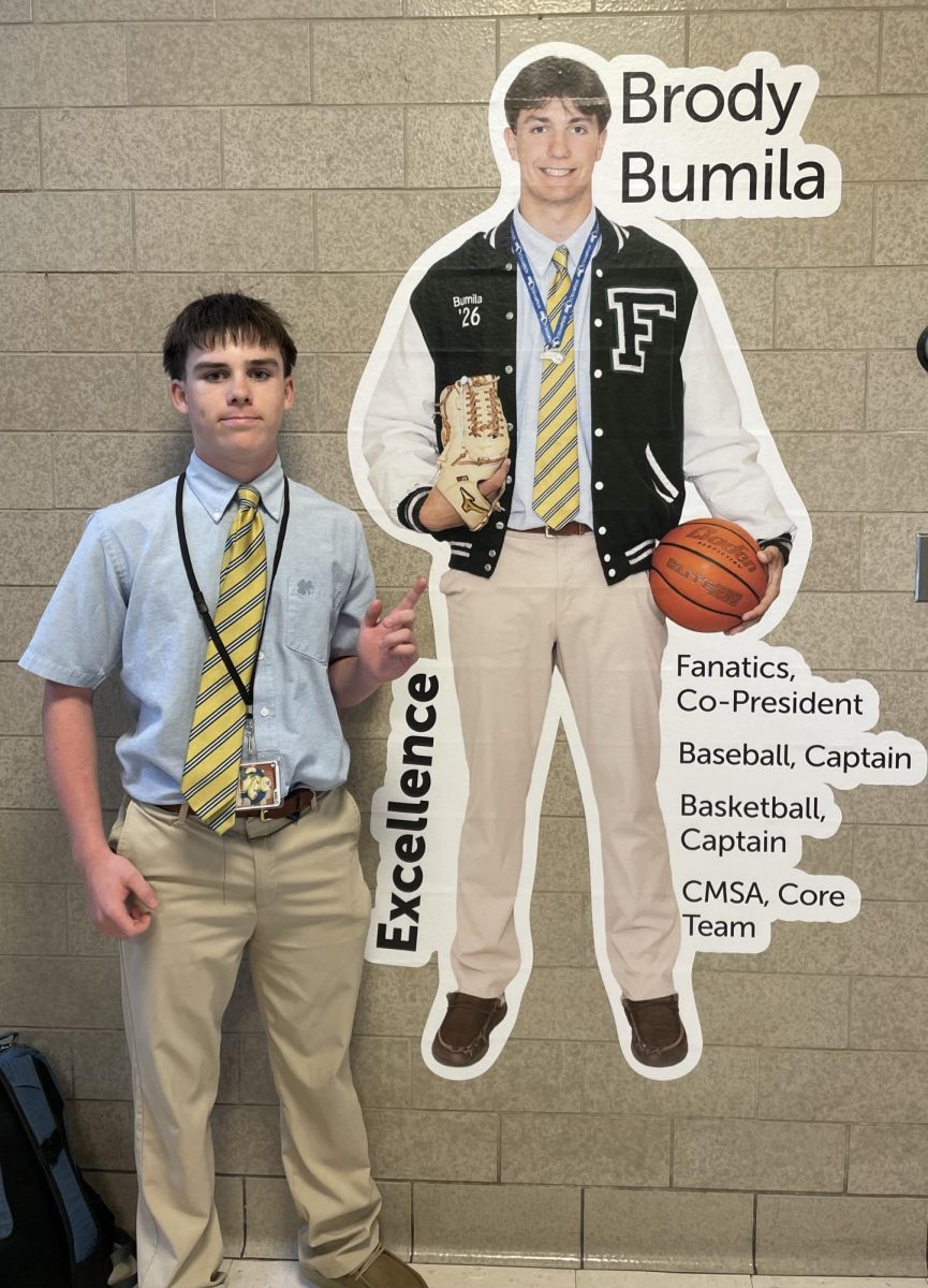 The article's reporter, Jimmy O'Keefe with Brody's tribute "Fathead" display